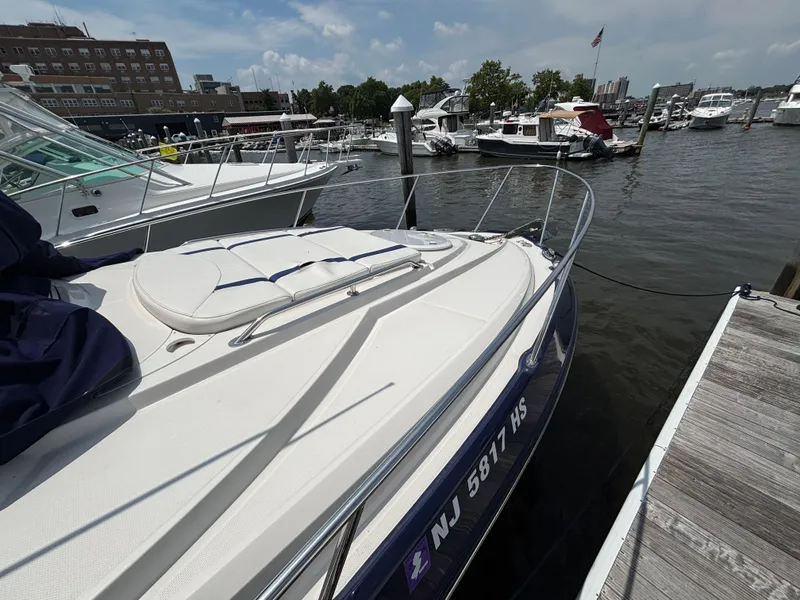 Slide: The Image of 2013 Monterey 280 SCR boat docked at marina, surrounded by other vessels. - 5