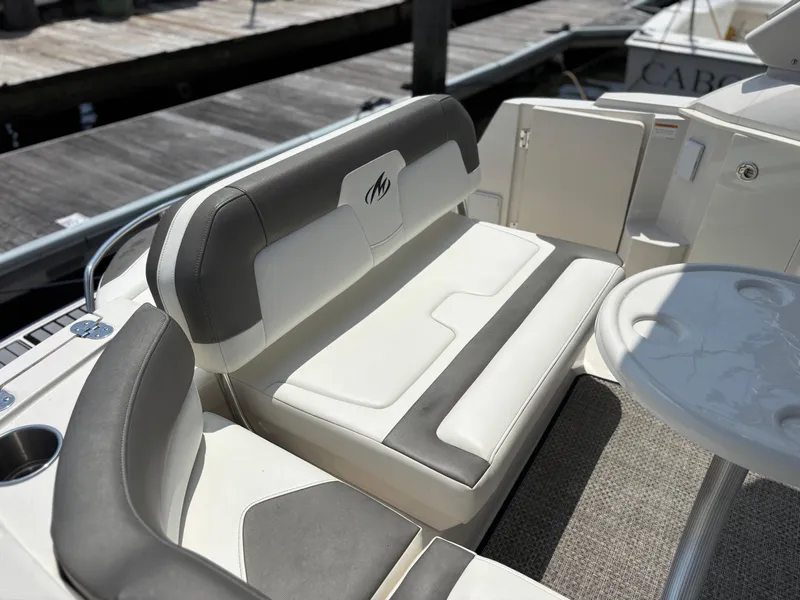 Slide: The Image of 2013 Monterey 280 SCR boat interior with cushioned seating and table. - 9