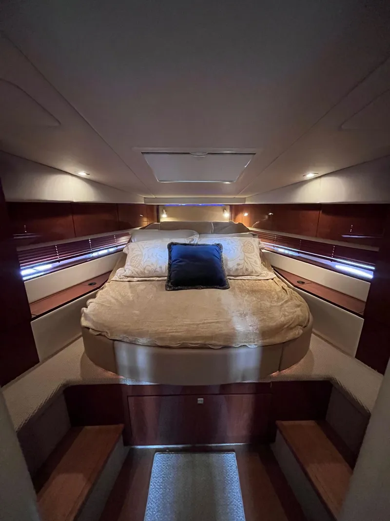 Slide: The Image of Luxurious cabin interior of 2013 Sea Ray 450 Sundancer yacht with cozy bed and ambient lighting. - 14