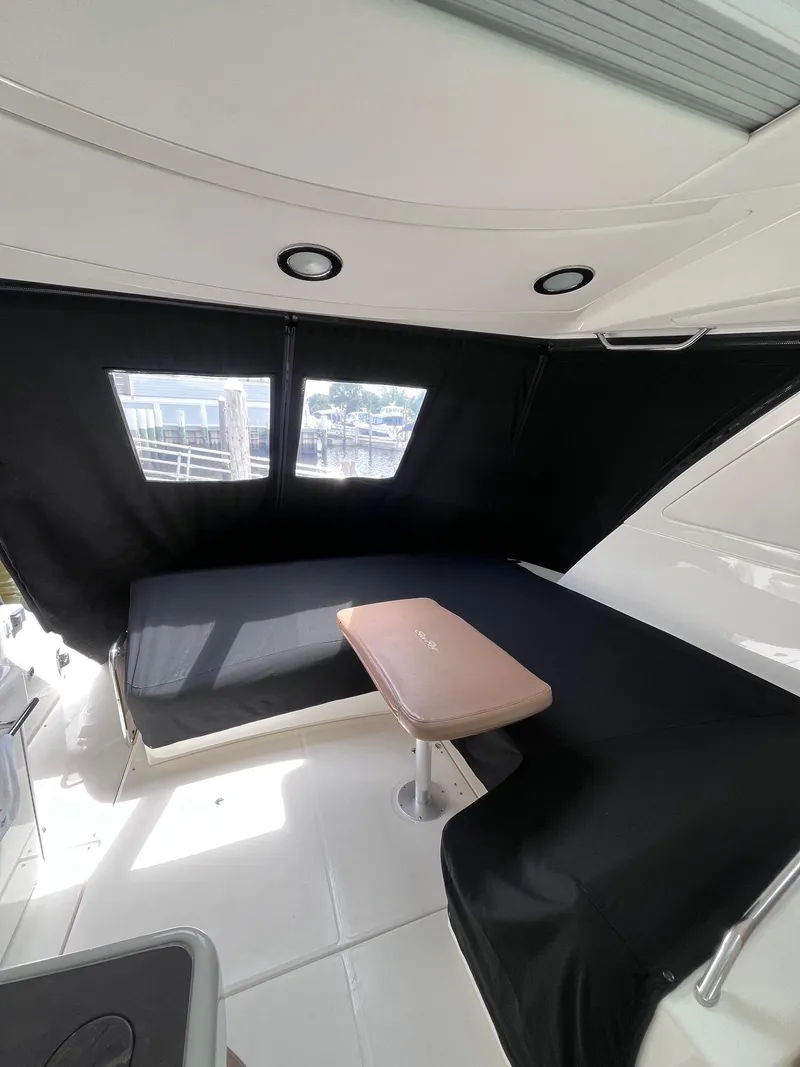Slide: The Image of Interior of 2013 Sea Ray 450 Sundancer yacht with black seating and table. - 19