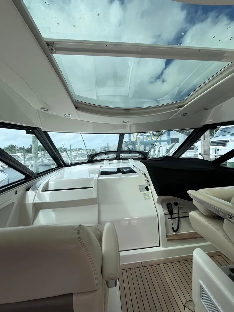 Slide: The Image of Interior view of 2013 Sea Ray 450 Sundancer yacht with glass roof and modern helm. - 20
