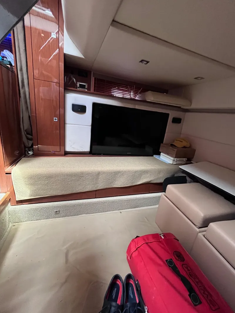 Slide: The Image of Interior of 2013 Sea Ray 450 Sundancer yacht with TV and seating area. - 23