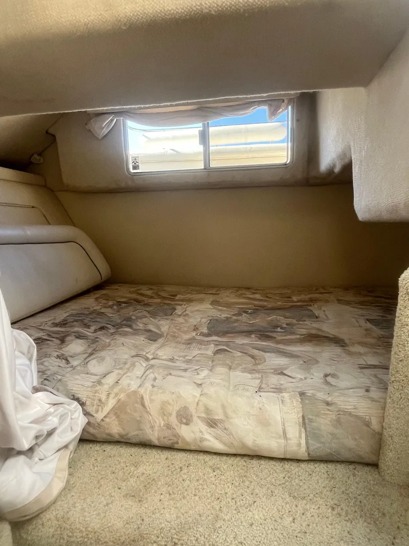 Slide: The Image of Cozy cabin interior of 1996 Maxum 2700 SCR boat with window view. - 12