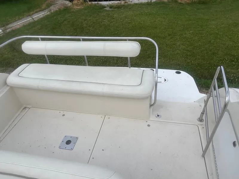 Slide: The Image of 1996 Maxum 2700 SCR boat interior with white seating and metal railings. - 7