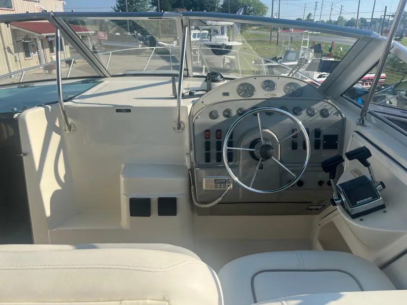 Slide: The Image of 1996 Maxum 2700 SCR boat cockpit with steering wheel and control panel. - 8