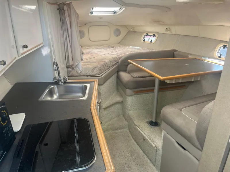 Slide: The Image of Interior of a 1996 Maxum 2700 SCR boat with kitchenette and seating area. - 9