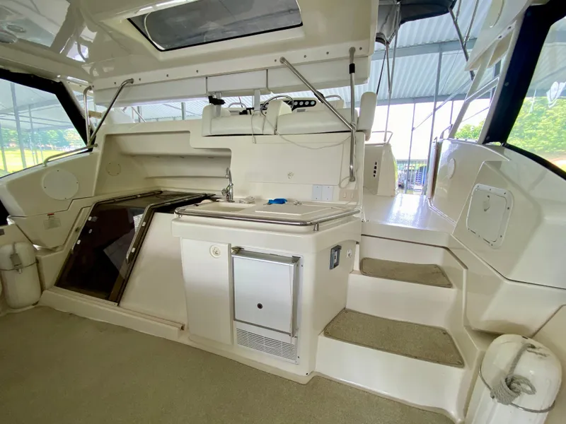 Slide: The Image of 1997 Silverton 372 Motor Yacht interior with helm and seating area. - 11