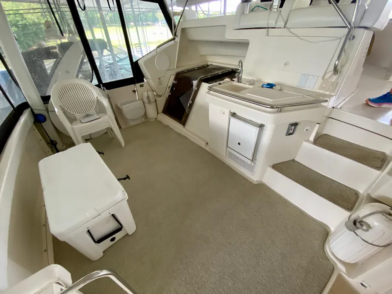 Slide: The Image of 1997 Silverton 372 Motor Yacht interior with kitchenette, seating, and stairs. - 12