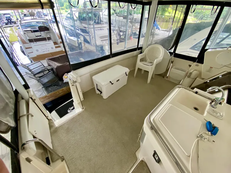 Slide: The Image of 1997 Silverton 372 Motor Yacht interior with seating, sink, and cooler. - 13