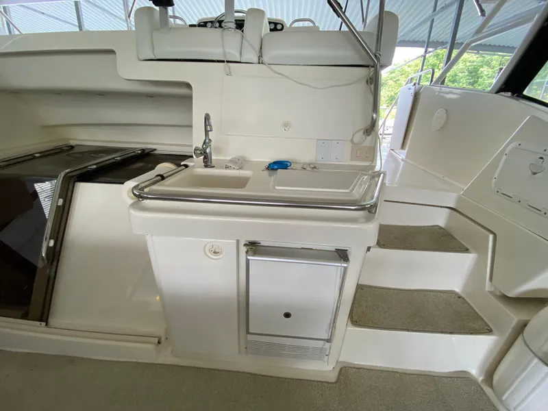 Slide: The Image of 1997 Silverton 372 Motor Yacht interior with sink and stairs, showcasing sleek design. - 14