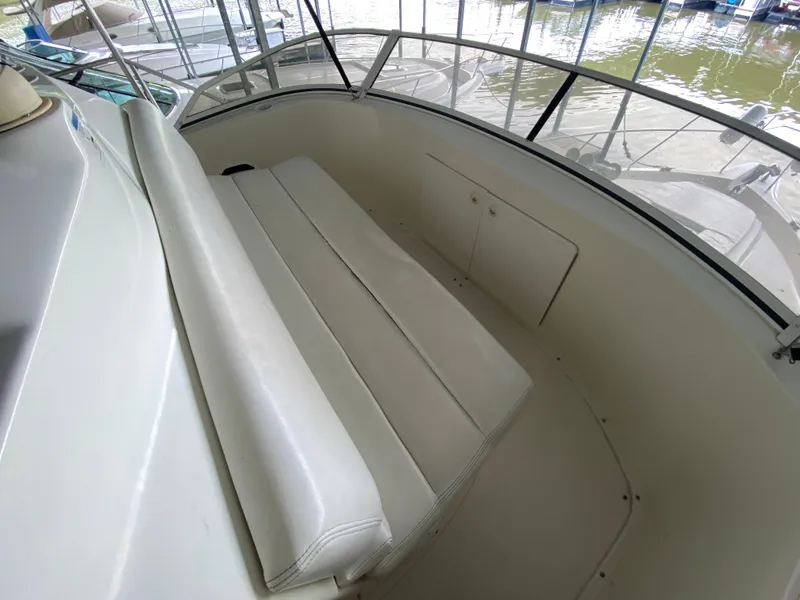 Slide: The Image of 1997 Silverton 372 Motor Yacht interior seating area with white upholstery. - 18