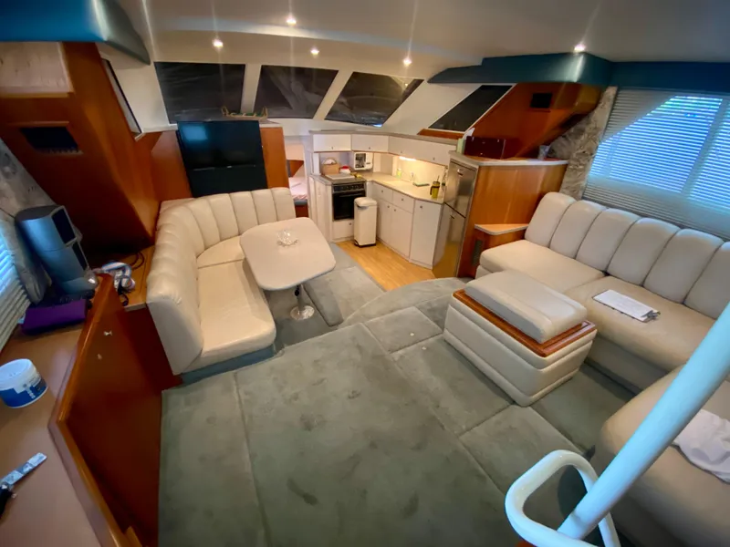 Slide: The Image of Luxurious interior of a 1997 Silverton 372 Motor Yacht with plush seating and modern amenities. - 21