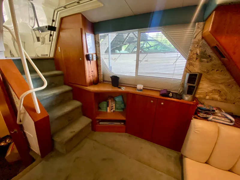 Slide: The Image of Interior of 1997 Silverton 372 Motor Yacht with wooden cabinetry and carpeted stairs. - 23
