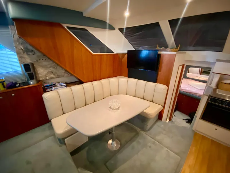 Slide: The Image of Interior of 1997 Silverton 372 Motor Yacht with cozy dining area and modern amenities. - 24
