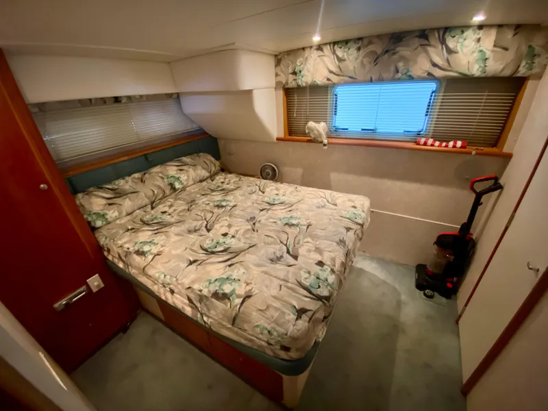 Slide: The Image of Cozy bedroom in 1997 Silverton 372 Motor Yacht with floral bedding and window view. - 27