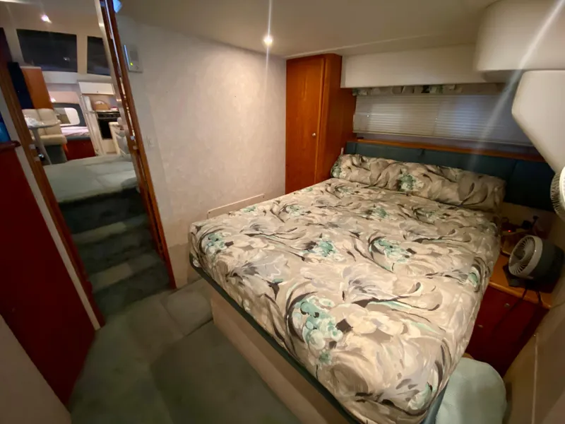 Slide: The Image of Interior of 1997 Silverton 372 Motor Yacht with cozy bedroom and floral bedding. - 28