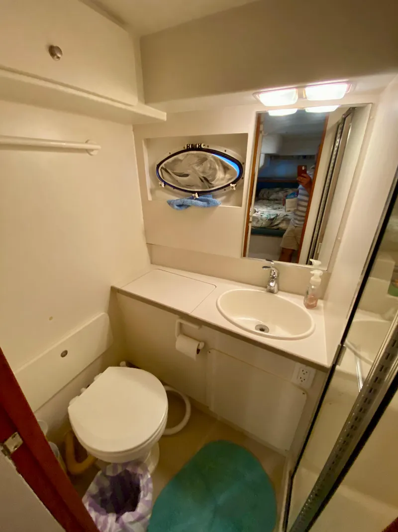 Slide: The Image of 1997 Silverton 372 Motor Yacht bathroom with sink, toilet, and mirror. - 30