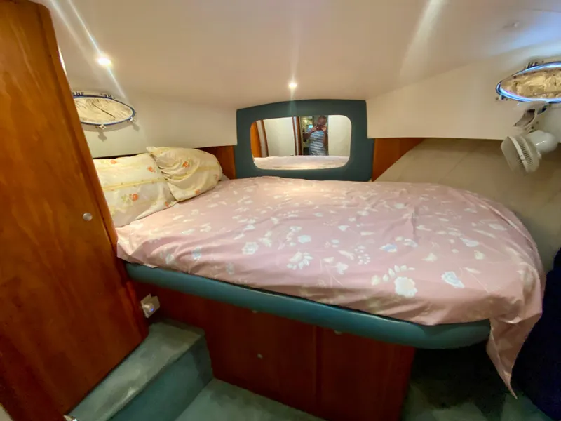 Slide: The Image of Cozy bedroom in 1997 Silverton 372 Motor Yacht with floral bedding and wooden accents. - 32