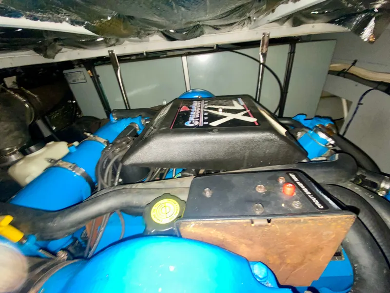 Slide: The Image of Engine compartment of a 1997 Silverton 372 Motor Yacht, featuring blue components and wiring. - 35
