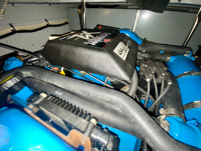 Slide: The Image of Engine compartment of a 1997 Silverton 372 Motor Yacht, featuring blue components. - 36
