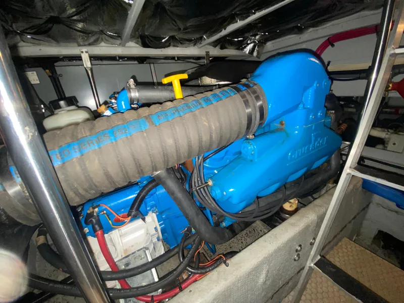 Slide: The Image of Engine compartment of a 1997 Silverton 372 Motor Yacht, featuring a blue Crusader engine. - 39