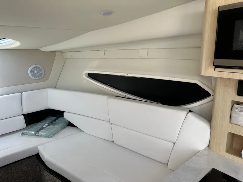 Slide: The Image of 2024 Regal 26 XO boat interior with white seating and modern amenities. - 10