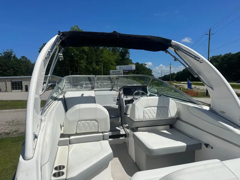Slide: The Image of 2024 Regal 26 XO boat interior with white seating and black canopy. - 16