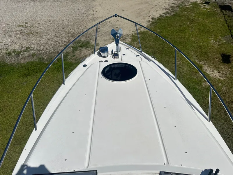 Slide: The Image of 2024 Regal 26 XO boat deck with railing, viewed from above on grassy terrain. - 18