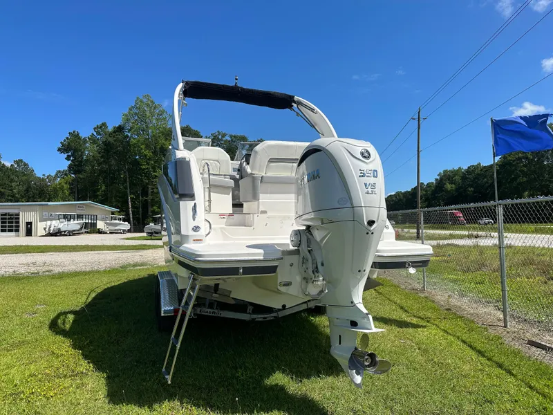 Slide: The Image of 2024 Regal 26 XO boat with Yamaha 350 V8 engine on grassy lot. - 2