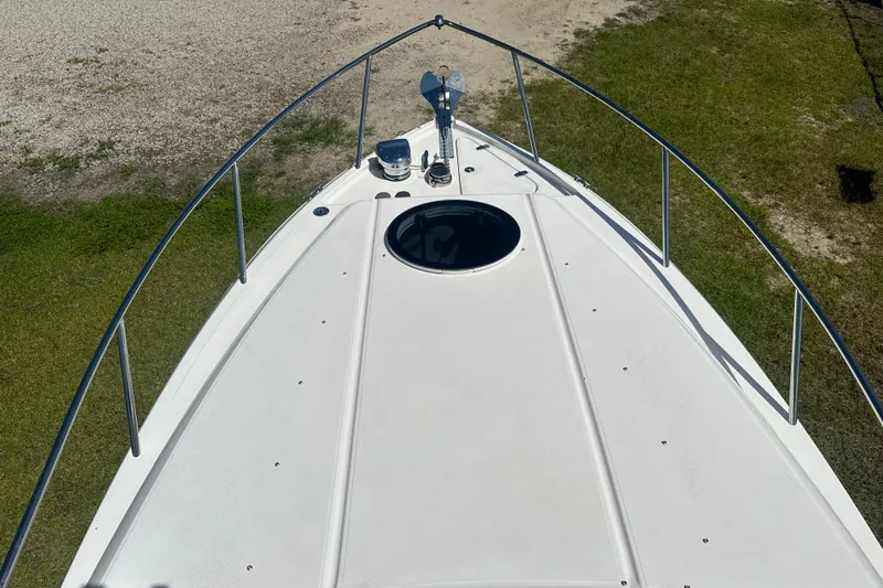 Slide: The Image of 2024 Regal 26 XO boat deck with railing, viewed from above on grassy terrain. - 20
