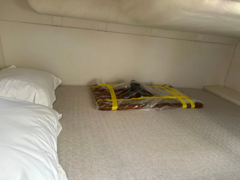 Slide: The Image of 2024 Regal 26 XO cabin interior with bed and packaged item. - 23