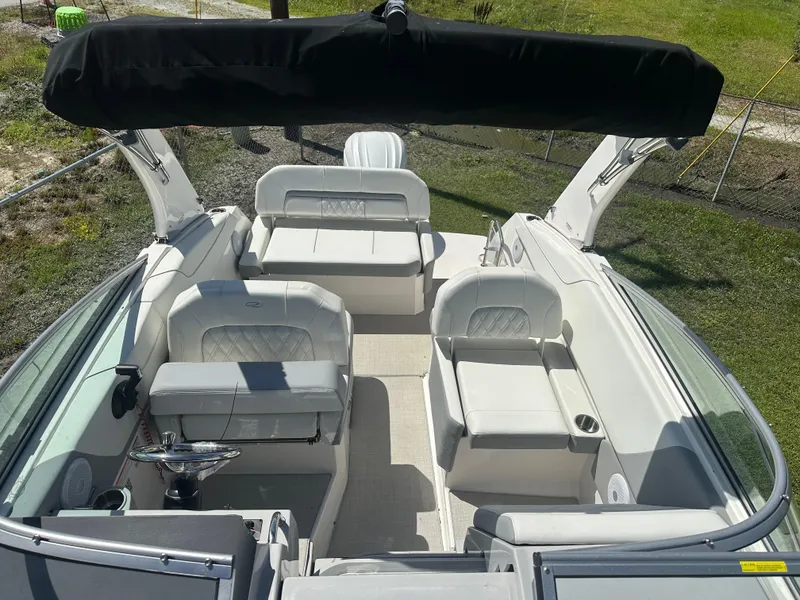 Slide: The Image of 2024 Regal 26 XO boat interior with white seating and black canopy. - 4