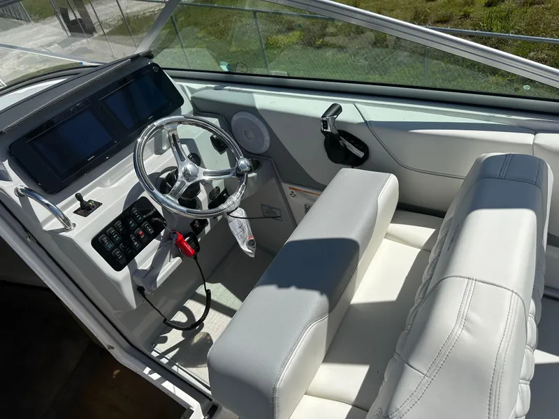 Slide: The Image of 2024 Regal 26 XO boat cockpit with modern steering and dual displays. - 5
