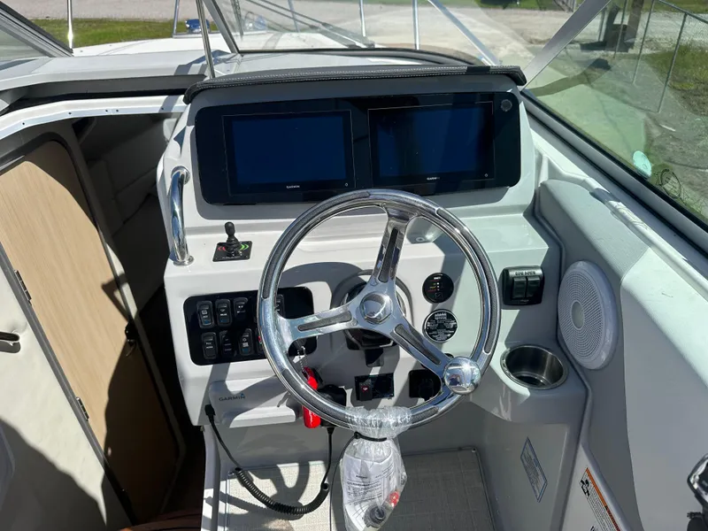 Slide: The Image of 2024 Regal 26 XO boat helm with dual screens and modern controls. - 6