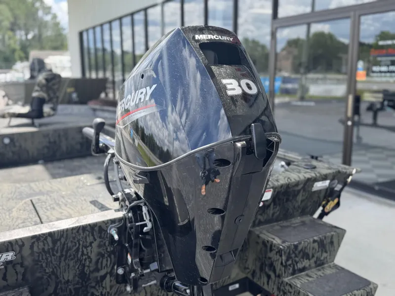 Slide: The Image of 2026 Tracker Grizzly 1654 T Sportsman with Mercury 30 outboard motor, outdoors. - 14