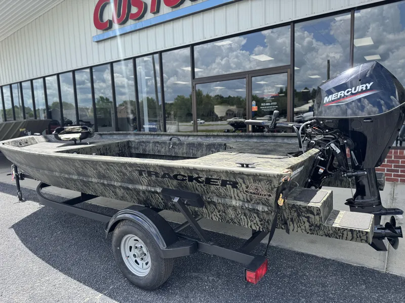 Slide: The Image of 2026 Tracker Grizzly 1654 T Sportsman boat with Mercury engine on trailer, outside dealership. - 3