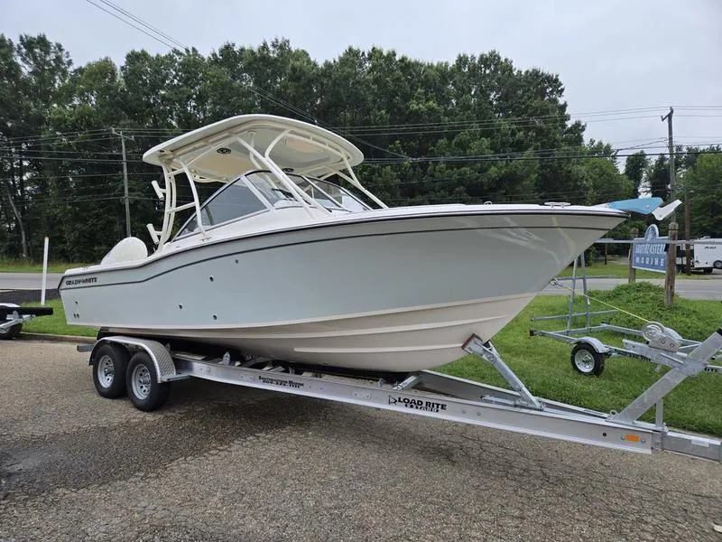 The Image of 2026 Grady-White Freedom 255 boat on trailer, parked outdoors. - 1
