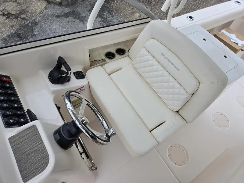 Slide: The Image of 2026 Grady-White Freedom 255 boat interior with steering wheel and cushioned seat. - 10