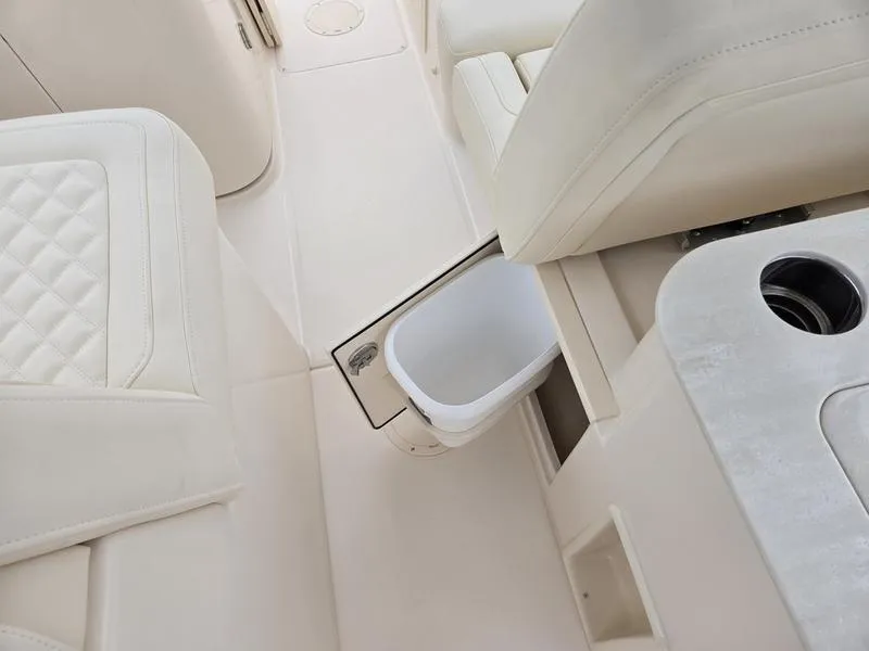 Slide: The Image of 2026 Grady-White Freedom 255 interior with white seating and built-in storage compartment. - 11