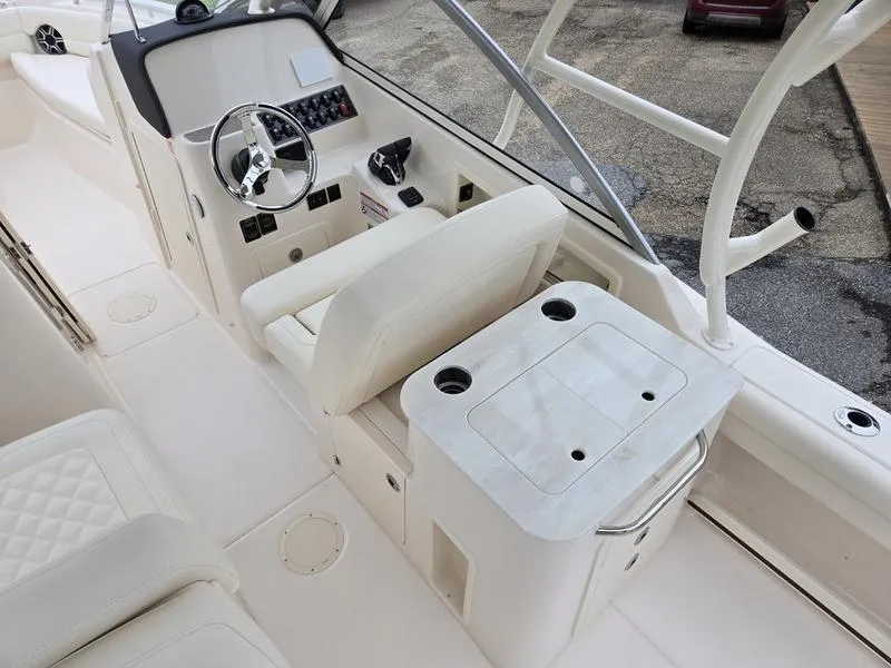 Slide: The Image of 2026 Grady-White Freedom 255 boat interior with helm, seating, and storage features. - 14