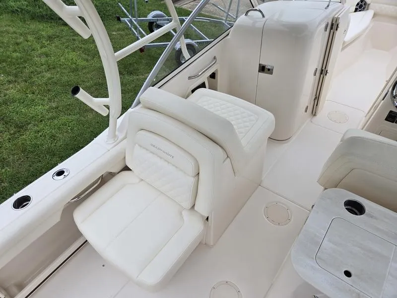 Slide: The Image of 2026 Grady-White Freedom 255 boat interior with white seating and helm area. - 15