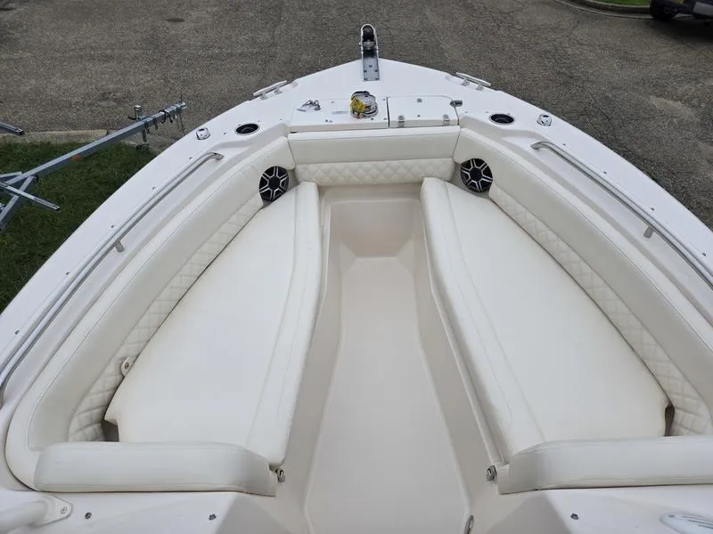 Slide: The Image of 2026 Grady-White Freedom 255 boat interior with white cushioned seating. - 20