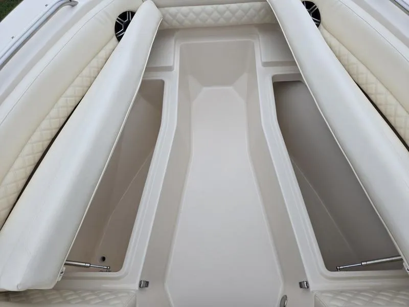 Slide: The Image of 2026 Grady-White Freedom 255 boat interior with cushioned seating and storage compartments. - 23