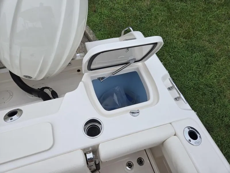 Slide: The Image of 2026 Grady-White Freedom 255 boat interior with open storage compartment and seating. - 5