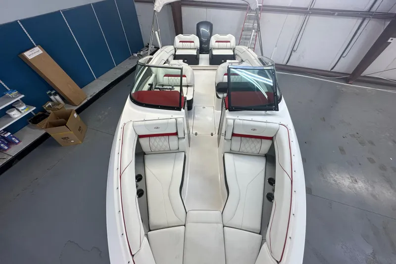 Slide: The Image of 2022 Regal LX4 boat interior with white and red seating in a garage setting. - 3