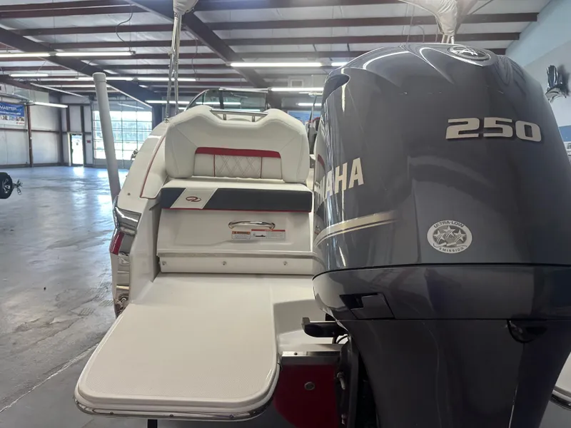 Slide: The Image of 2022 Regal LX4 boat with Yamaha 250 engine in a spacious indoor showroom. - 4