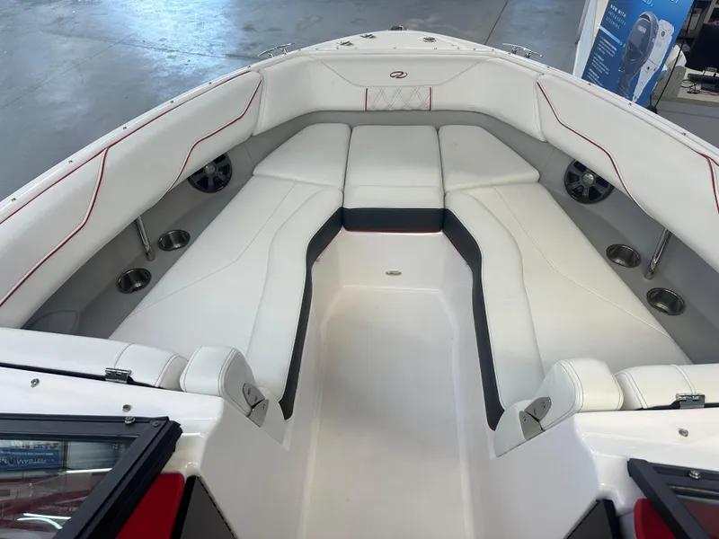 Slide: The Image of 2022 Regal LX4 boat interior with white seating and cup holders. - 7