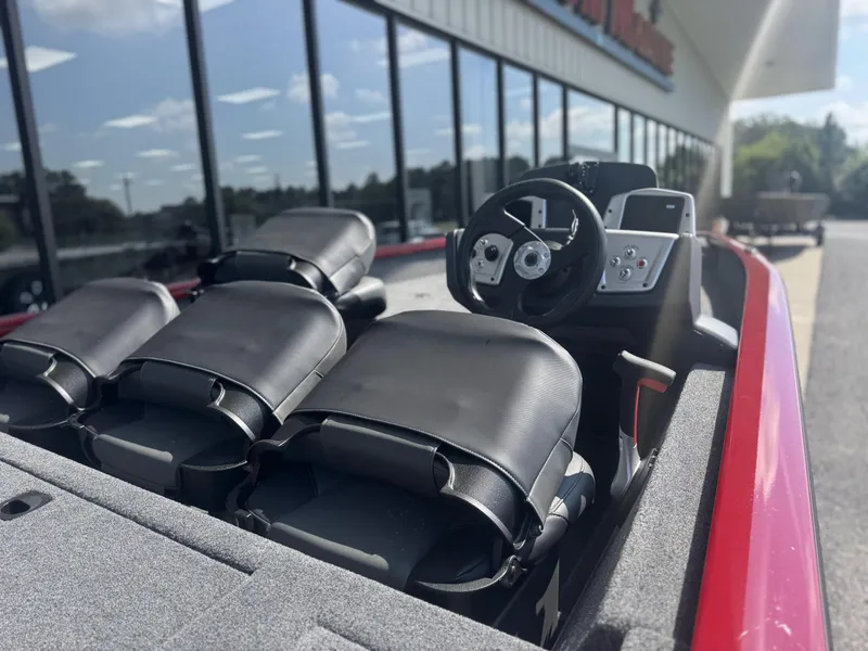 Slide: The Image of 2026 Tracker Pro Team 175 Crappie Edition boat interior with steering wheel and seats. - 2