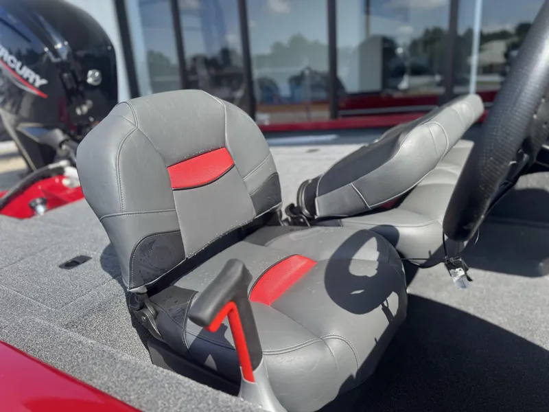 Slide: The Image of 2026 Tracker Pro Team 175 Crappie Edition boat seats with red accents and Mercury engine. - 4