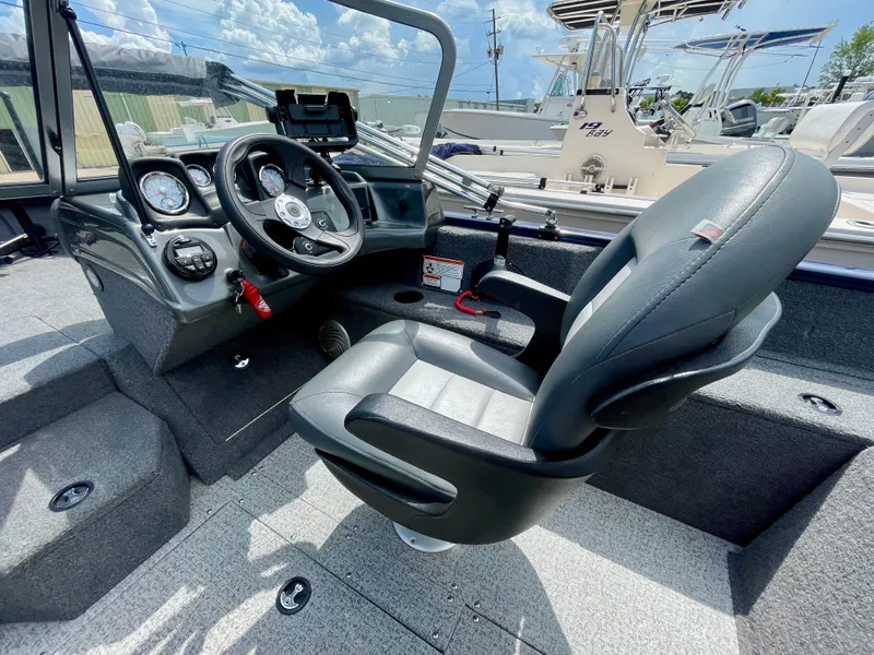 Slide: The Image of 2020 Tracker Pro Guide V-175 Combo boat interior with steering wheel and captain's chair. - 13